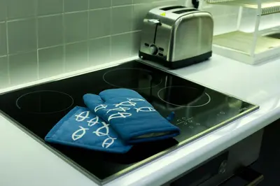 a kitchen sink with two blue towels and a toaster at El Pacífico in Athens