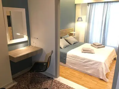 a small bedroom with a bed and a mirror at El Pacífico in Athens