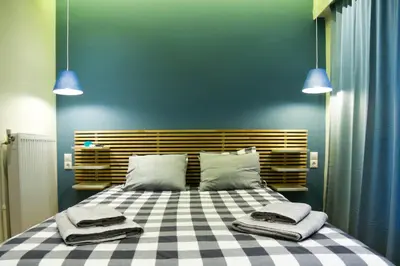a bedroom with a large bed with two towels on it at El Pacífico in Athens