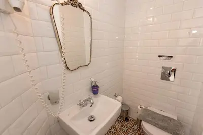 a white bathroom with a sink and a toilet at City Circus Athens in Athens
