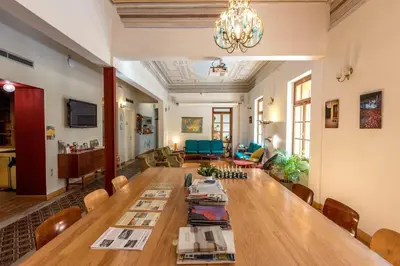 a living room with a large wooden table and chairs at City Circus Athens in Athens