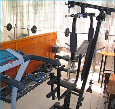 a room with a gym with a treadmill at Costantonia Holiday Apartments in Agia Marina Aegina