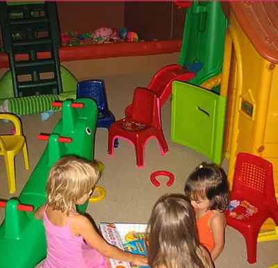 two little girls playing in a toy room at Costantonia Holiday Apartments in Agia Marina Aegina