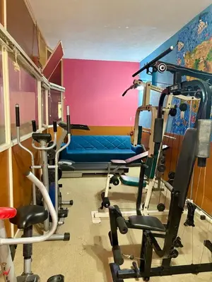 a room with a gym with a blue chair in it at Costantonia Holiday Apartments in Agia Marina Aegina