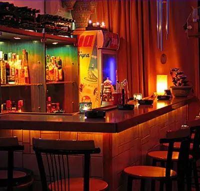a bar in a restaurant with chairs and a counter at Costantonia Holiday Apartments in Agia Marina Aegina