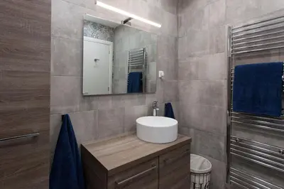 a bathroom with a sink and a mirror at Lovely 2 bedroom apt in Metaxourgio Center in Athens
