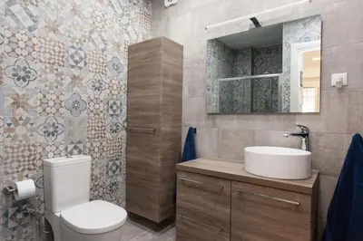 a bathroom with a toilet and a sink and a mirror at Lovely 2 bedroom apt in Metaxourgio Center in Athens