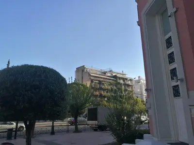 a view of a building in a city with trees at Comfortable & Convenient Living in Athens in Athens