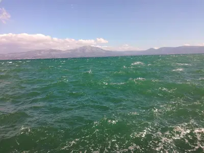 a large body of water with mountains in the background at Comfortable & Convenient Living in Athens in Athens