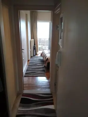 a hallway leading to a living room with a window at George's Apartment in Athens