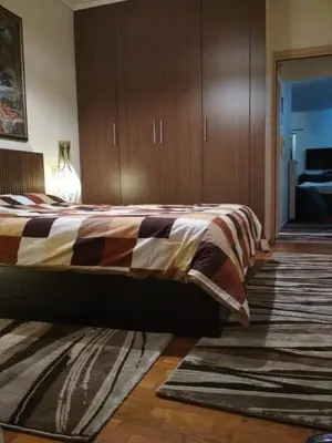 a bedroom with a bed with a vase on it at George's Apartment in Athens