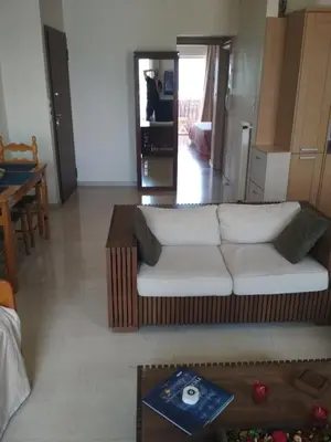 a living room with a couch and a table at George's Apartment in Athens