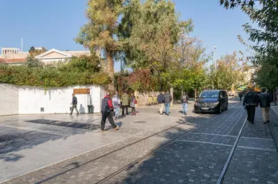 a group of people walking down a street at Acropolis Suites - Where else in Athens? in Athens