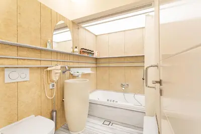a bathroom with a toilet and a bath tub at Acropolis Suites - Where else in Athens? in Athens
