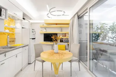 a kitchen with a yellow table and chairs at Acropolis Suites - Where else in Athens? in Athens