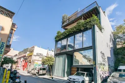 a building with plants on the side of a street at So Athens - Studios and Apartments in Athens