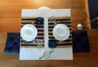 a table with two plates and glasses on a table at So Athens - Studios and Apartments in Athens