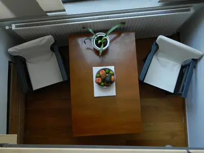 a table with a bowl of fruit on top of it at So Athens - Studios and Apartments in Athens