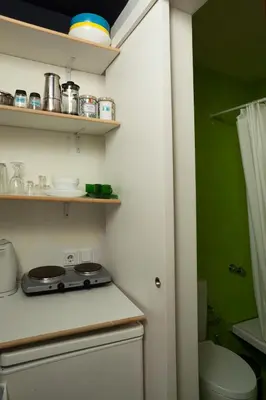 a kitchen with a stove and a green wall at So Athens - Studios and Apartments in Athens