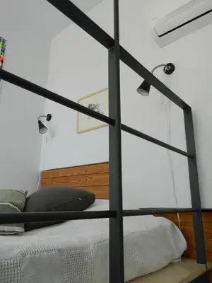 a bedroom with a bed with a glass wall at So Athens - Studios and Apartments in Athens