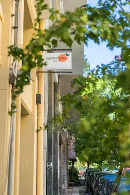 a street sign on the side of a building at Neratzia Rooms in Athens