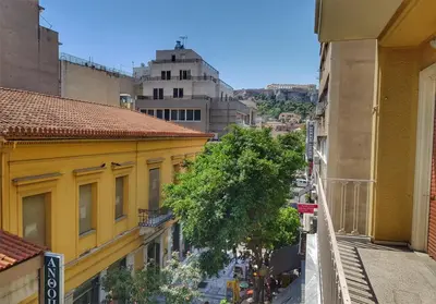 a view of a city street from a yellow building at Let me Athens you! in Athens