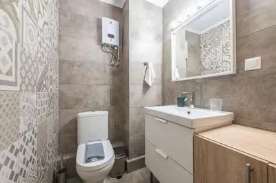 a bathroom with a toilet and a sink and a mirror at Let me Athens you! in Athens