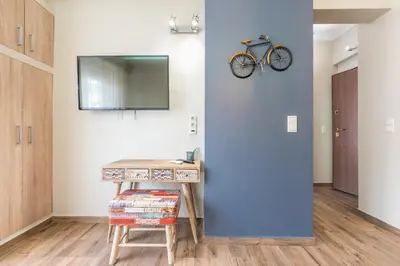 a room with a desk and a bike on the wall at Let me Athens you! #2 in Athens
