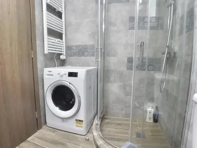 a washing machine in a bathroom with a shower at Let me Athens you! #2 in Athens