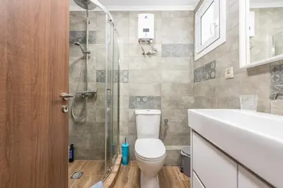 a bathroom with a shower and a toilet and a sink at Let me Athens you! #2 in Athens