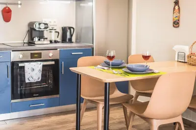 a kitchen with a table and two glasses of wine at Let me Athens you! #2 in Athens