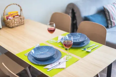 a wooden table with two glasses of red wine at Let me Athens you! #2 in Athens