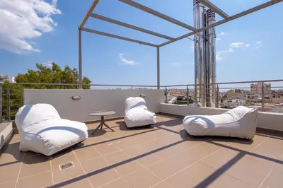 two white chairs and a table on a roof at Solon - Deluxe City Center Apartment in Athens