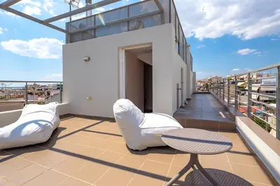 a balcony with a table and chairs on a building at Solon - Deluxe City Center Apartment in Athens