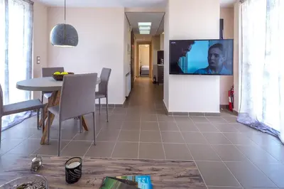a living room with a table and a tv on a wall at Solon - Deluxe City Center Apartment in Athens