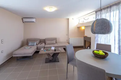 a living room with a couch and a table at Solon - Deluxe City Center Apartment in Athens