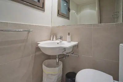 a bathroom with a sink and a toilet at Cozy and modern studio next to the sea in Athens