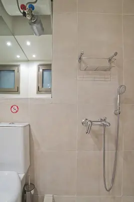 a shower stall in a bathroom with a toilet at Cozy and modern studio next to the sea in Athens