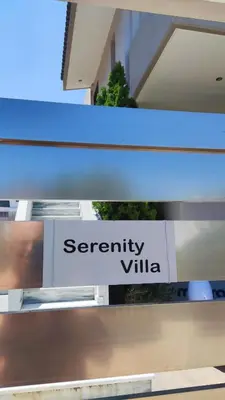 a sign that reads security villa on a building at Serenity Villa-1st floor-Panoramic Sea view- sea 150m away in Porto Rafti