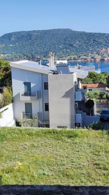 a white house on the side of a hill at Serenity Villa-1st floor-Panoramic Sea view- sea 150m away in Porto Rafti