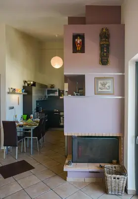 a living room with a fireplace and a dining room at Serenity Villa-1st floor-Panoramic Sea view- sea 150m away in Porto Rafti