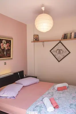 a bedroom with two beds and a light fixture at Serenity Villa-1st floor-Panoramic Sea view- sea 150m away in Porto Rafti