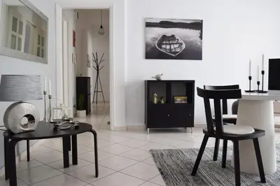 a living room with two chairs and a table at Poseidon by Heloni Apartments in Piraeus