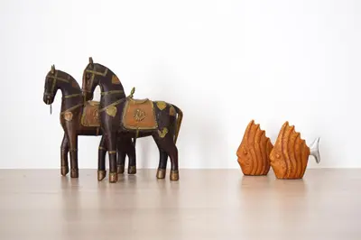 a wooden horse figurine sitting on top of a table at Poseidon by Heloni Apartments in Piraeus