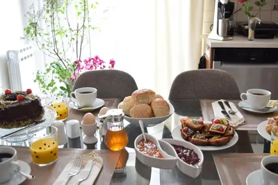 a table with a breakfast of eggs and pastries at Poseidon by Heloni Apartments in Piraeus