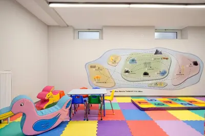 a room with a table and chairs and a mural at Hercules Residence in Athens