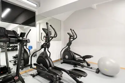 a gym with several exercise bikes in a room at Hercules Residence in Athens