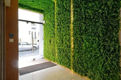 a wall covered in green ivy in a hallway at Hercules Residence in Athens