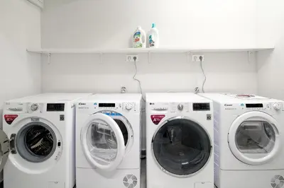 three washing machines and a washer and dryer in a room at Hercules Residence in Athens