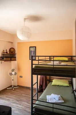 a room with three bunk beds and a lamp at Serenity Villa-Ground floor-Sea view- sea 150m away in Porto Rafti